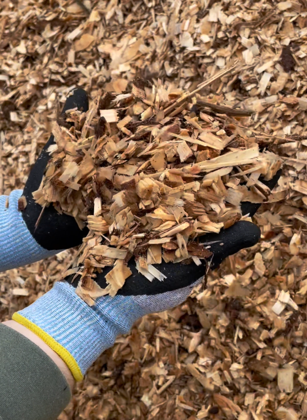 A sufficient layer of wood chips form a protective layer that inhibits weed growth